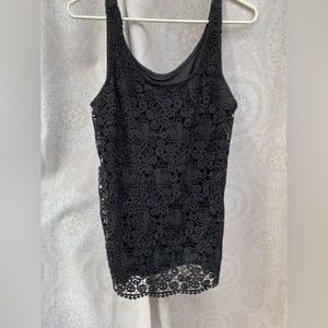 Tank top with lace on the front. Lg.  100% polyester. Material does stretch.